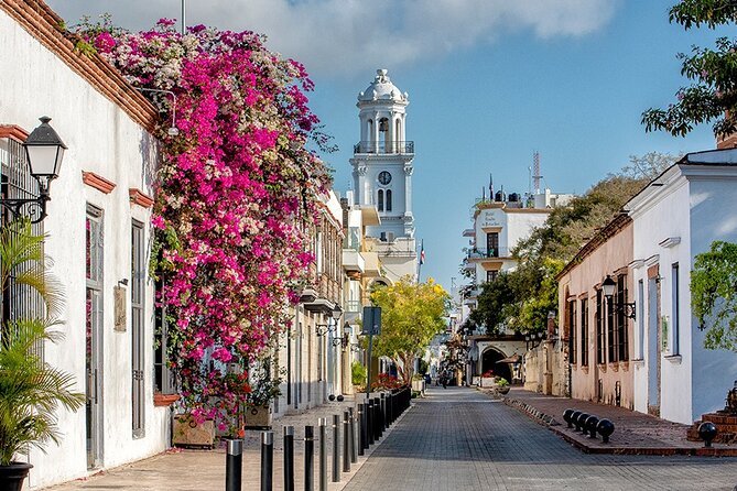 Street in the Colonial City of Santo Domingo with bougainvillea and a bell tower